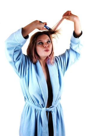 A woman in a blue bad rope, topless, brushing her hair, for white background.の写真素材