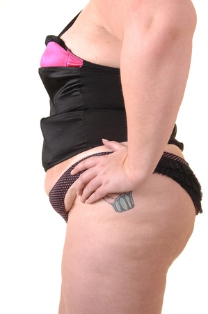 An big overweight woman standing in black lingerie and a small pantie in the studio, for white background.の写真素材