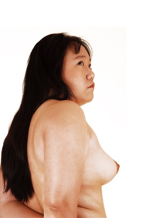The profile view of a pretty Asian woman topless and with long blackhair, showing her nice breast, for white background の写真素材