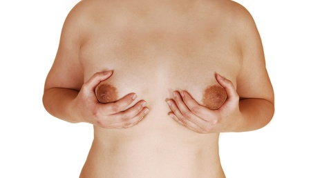 A closeup of the chest of a young Asian woman holding her breasts,for white background の写真素材