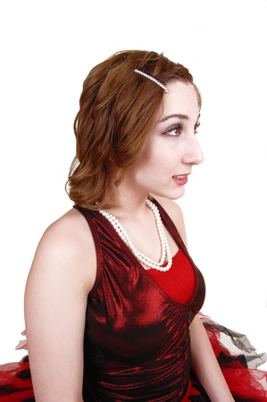 A portrait shot in profile of a lovely young teenager in a red and blackballet outfit for white background の写真素材