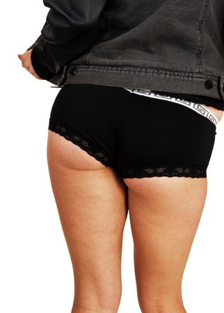 A body shot of a young woman in a black leather jacket and boys cut blackpanties for white background の写真素材