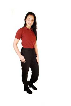 A lovely young teenage girl in her school uniform, burgundy short and longblack pants, standing in the studio for white background の写真素材