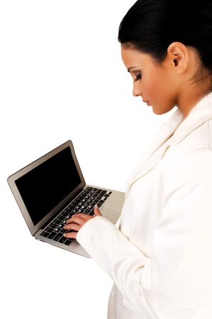 A closeup shoot of a pretty business woman, working on a laptop, in awhite business suit, on white background の写真素材