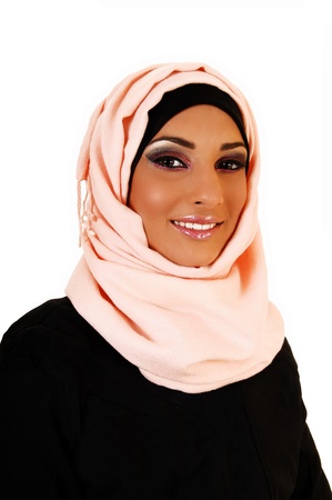 A young lovely teenager girl in a black jacket and a pink headscarf forwhite background, a portrait shoot of the girl smiling の写真素材