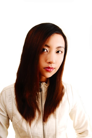 A portrait shoot of a young beautiful chinese woman for white backgroundin a white jacket and brunette hair の写真素材