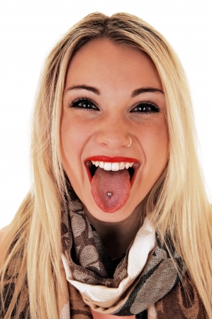 A very happy young woman showing her pierced tongue, smiling,for white background, in closeup の写真素材