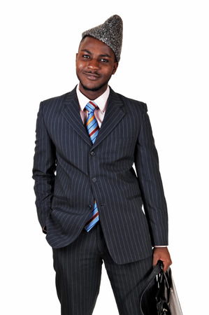 A smiling black young man in a blue suit and briefcase standing for whitebackground の写真素材