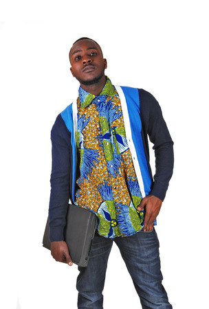 A handsome black man standing with his laptop on white background の写真素材