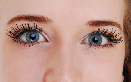 A closeup picture of the beautiful blue eyes of a young woman 