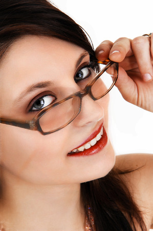 A extreme closeup pictures of the face of a beautiful young woman, holdingher glasses, isolated for white background の写真素材