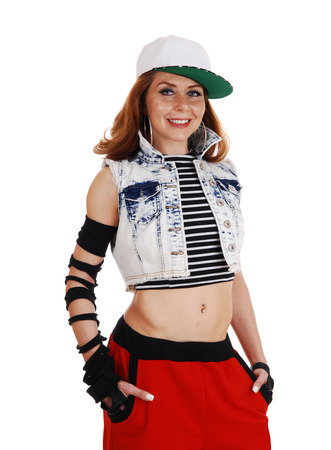 A hip hop woman in red pants, jeans jacket and a hat standingisolated on white background の写真素材