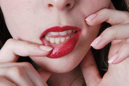 A closeup picture of the lips of a lovely teenager girlisolated for black background の写真素材