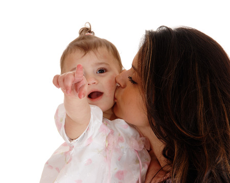 A closeup picture of a baby getting a kiss from her mom and pointingwith her finger, isolated for white background.の写真素材