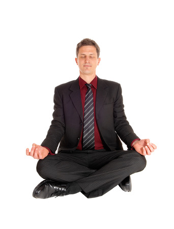 An business man in a suit sitting on the floor, glossing his eyeの写真素材