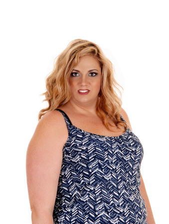 A beautiful plus sized young woman in a blue and white dress standing
isolated for white background.の写真素材