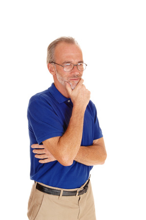 A waist up image of a middle age man in a blue t-shirt standing isolated
for white background.の写真素材