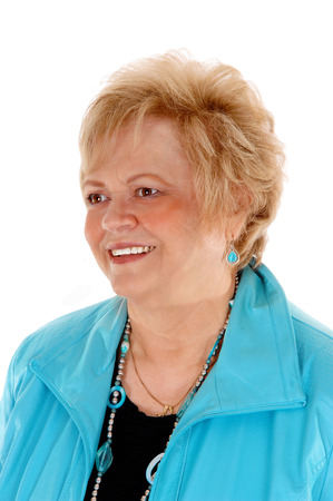 A portrait image of a blond older woman in a turquoise jacket, smiling, 
isolated for white background.の写真素材