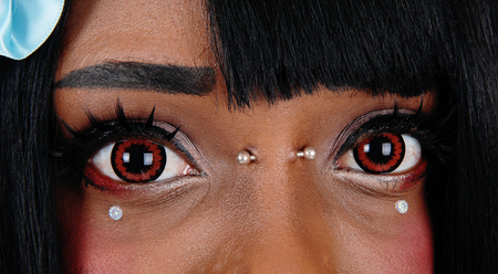 A closeup image of the beautiful big eyes of a African American woman
with some body piercing and brown eyes.の写真素材