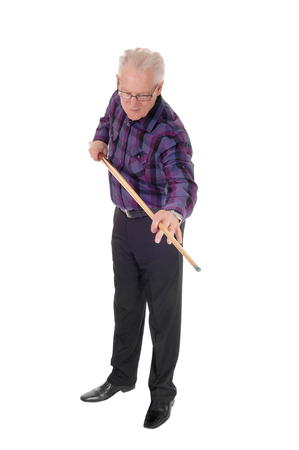 A handsome senior citizen standing isolated for white background and
praying his billiard game.の写真素材