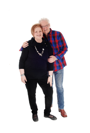 A lovely older couple standing in casual cloth, the man is holding his wife, smiling, isolated for white background.の写真素材