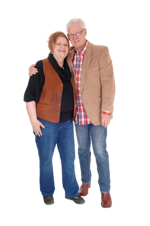A lovely older couple standing in casual clothing, smiling, isolated for white background.の写真素材