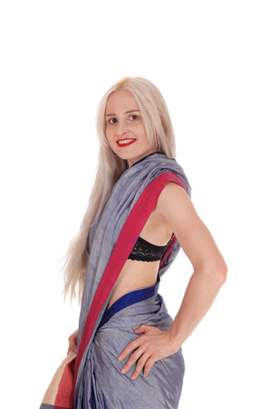 A beautiful blond woman in an East Indian outfit standing in profile,
smiling, isolated for white backgroundの写真素材