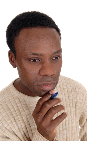 A portrait of the face of an African American handsome man with a pen
in his hand, thinking hard, isolated for white background
の写真素材