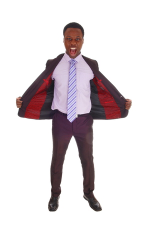 
A tall handsome African American man standing in a suit and tie
with his jacked open and shouting, isolated for white background
の写真素材