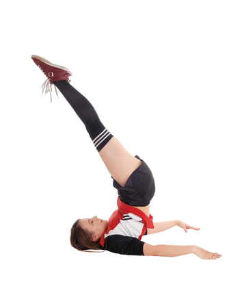 A young slim woman lying on the floor in the studio lifting her legs
up strait in the air, isolated for white background
の写真素材