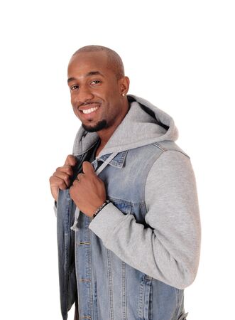 A close up image of a young African American man standing in a jeans
jacket in profile, isolated for white background
の写真素材