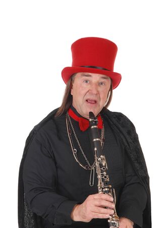 A middle age indigenous man playing his clarinet in a black outfit and
red hat and bow tie, isolated for white backgroundの写真素材