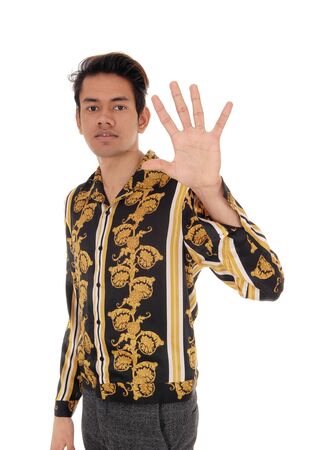 A tall young man standing in a gold colored shirt shoeing with one hand
saying ON, I would not do this, isolated for white backgroundの写真素材