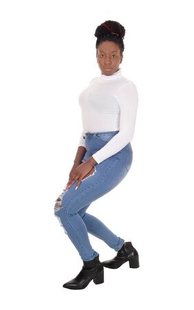 A young African American woman standing in jeans bending backwards,
isolated for white backgroundの写真素材
