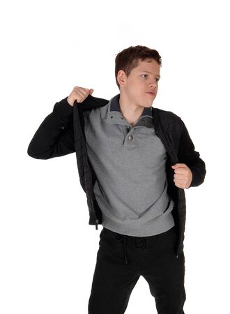 A sweet young teenage boy standing in the studio talking of his black
jacket, isolated for white background
の写真素材