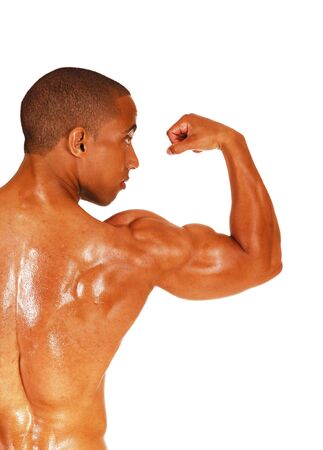 A young man standing from the back in the studio and showing his biceps
shirtless, isolated for white background
の写真素材