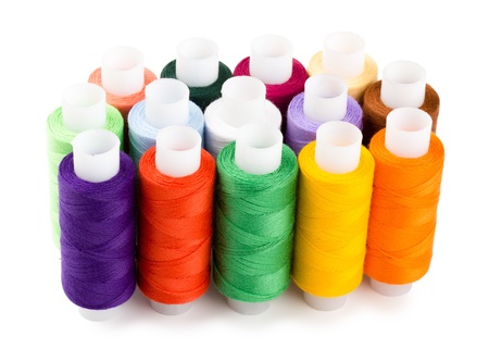 Spools multi-colored threads standing group isolated on a white background