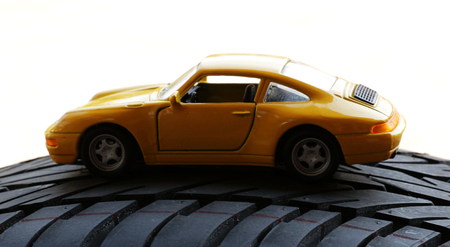 Toy car on an actual car tyre  tire の写真素材