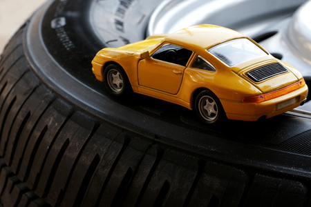 Toy car on an actual car tyre  tire の写真素材