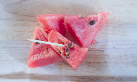 Watermelon sliced on wood backgroundの写真素材