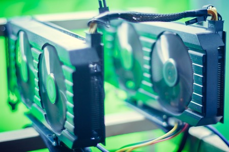Video card mining rig on the frame. In the frame are two video cards with wires.