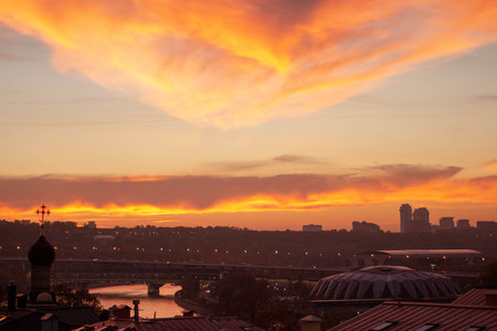Big metropolis against the backdrop of a beautiful sunset in the fall. Colors are orange, pink and red.の写真素材