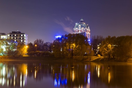 High-rise houses of a residential complex with night lighting. Expensive housing evening time.の写真素材