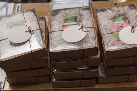 A stack of Christmas gifts cookies pig in boxes on the table