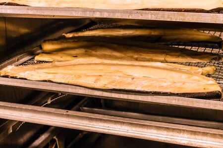 Hot smoked fish. Fish production in progressの写真素材