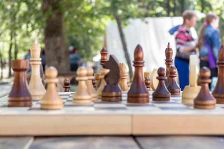 Chess is placed on the board. The game is on the street