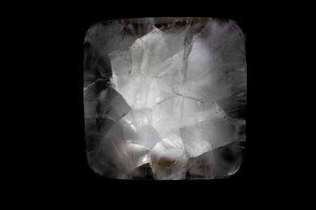 Abstract crystalline structure in stark contrast against a deep black background reveals intricate...