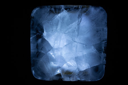 A Frozen Cube Of Ice Illuminated With Dramatic Blue Lighting Against A Dark Backdrop