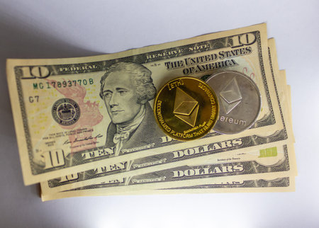 Ten Us Dollars And Ethereum Cryptocurrency Coin On Top Of Stacked Currency