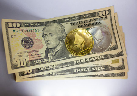 Convergence Of Traditional Finance And Cryptocurrency: Ten Dollar Bills With Ethereum Coinの写真素材